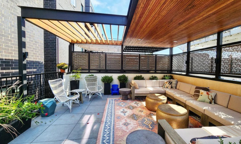 cozy rooftop deck with metal screening, outdoor furnitures and covering pergola